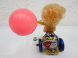 Vintage Mid Century Wind-Up Toy, Blond Girl Riding a Tricycle with Pink Balloon
